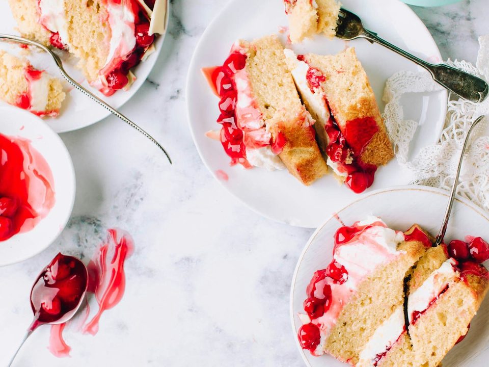 Picture 3: sliced cakes beside stainless steel forks on round white ceramic plates